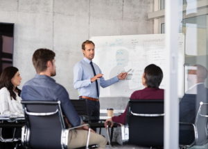 businessman explaining on a white board in a meeting