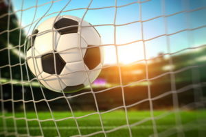 football in back of the net