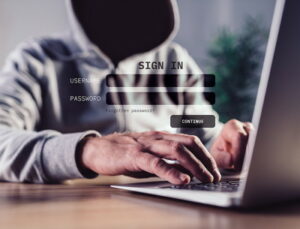 phishing man in hoodie login information being stolen